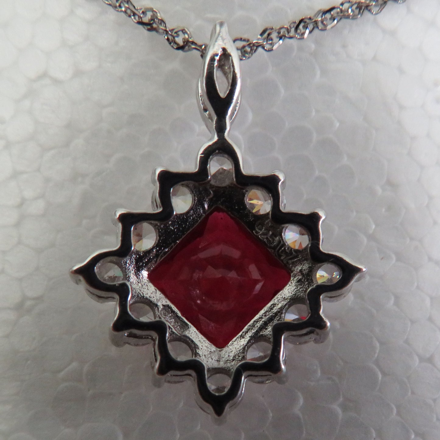 925 Silver Pendant Set With A Manufactured Ruby Surrounded By Claw Set Cubic Zirconia