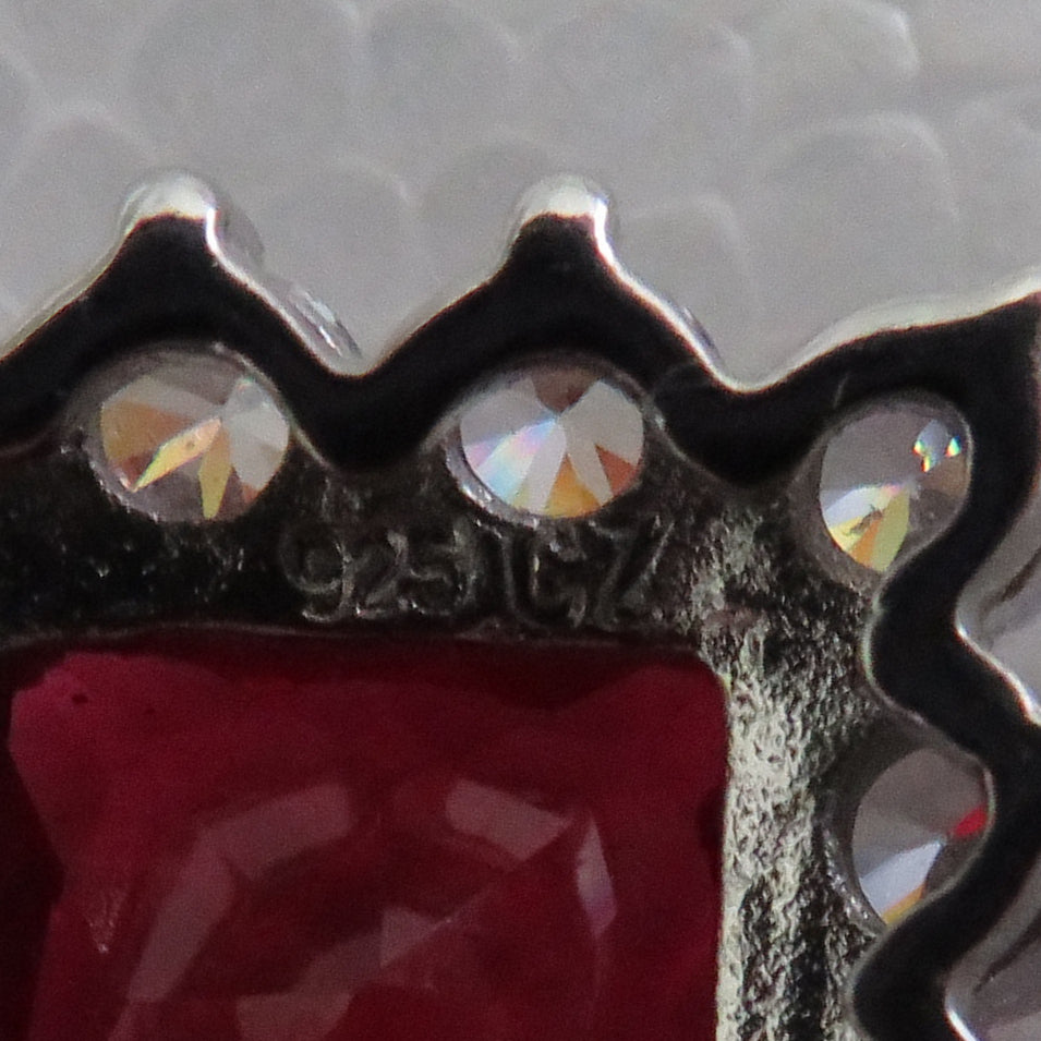 925 Silver Pendant Set With A Manufactured Ruby Surrounded By Claw Set Cubic Zirconia