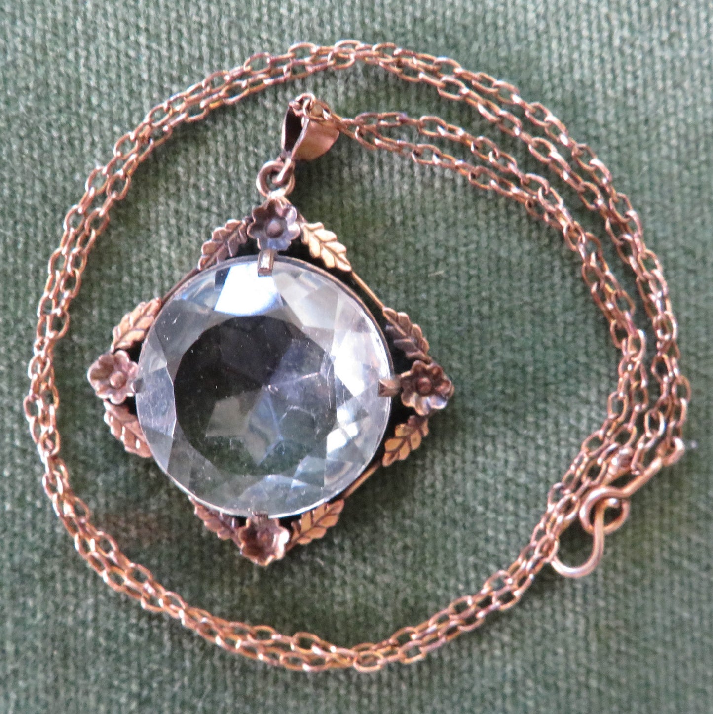 Gold Lined Pendant With Foliate Decorated Border Set With A Large Round Multi Faceted Claw Set Paste Simulate