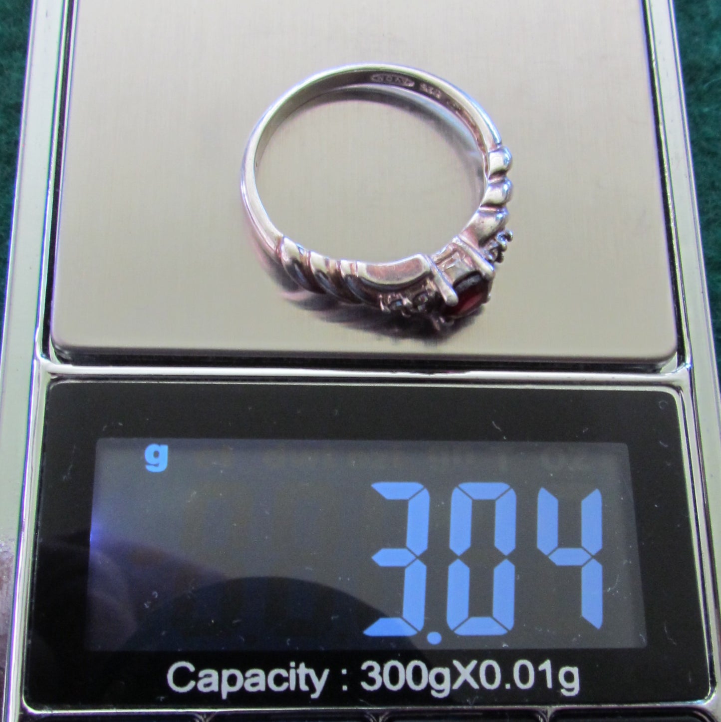 925 Sterling Silver Dress Ring Set With A Garnet Having Clear Shoulder Stones