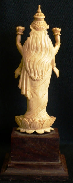 Ivory figure of Lord Vishnu standing on a Lotus flower India late 19th century mounted on a rosewood base