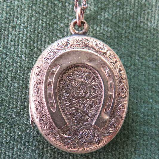 Unmarked Gold Oval Shaped Photo Locket Having A Horshoe Motif With Chain