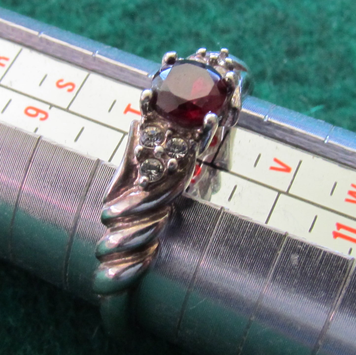 925 Sterling Silver Dress Ring Set With A Garnet Having Clear Shoulder Stones