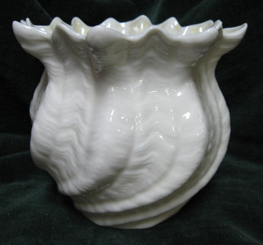 Irish Belleek shell vase with white opalescent body and yellow inner rim