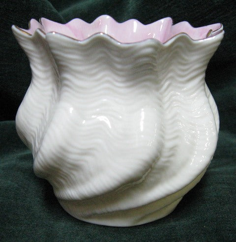 Irish Belleek shell vase with white opalescent body and pink/mauve inner rim with gilt edge