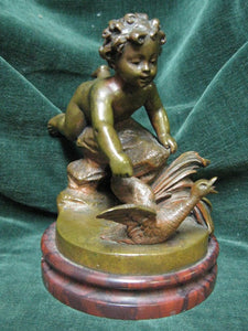 Bronze figure of a cherub chasing a goose on a round marble base early 1900s