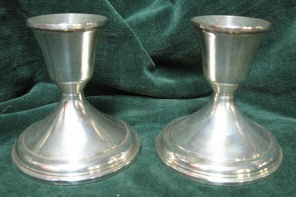 Pair of silver candlestick with weghted bases manufactured in America