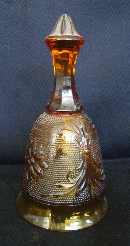 Fenton amber glass bell with faceted stem and high relief decorated body