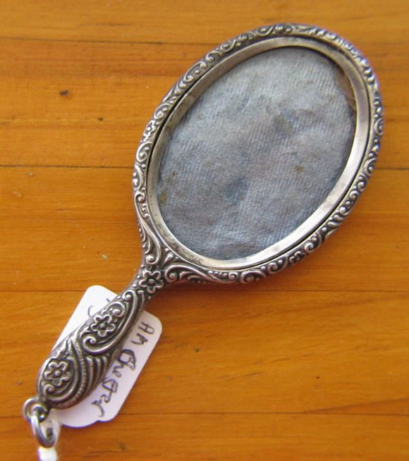 Sterling silver miniature hand mirror photo locket for chatelaine or pendant hallmarked Chester c1904 with pressed decoration. Car touche is not engraved.