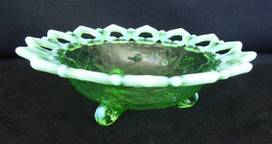 Green glass tri footed dish with opalescent / vaseline loop edge